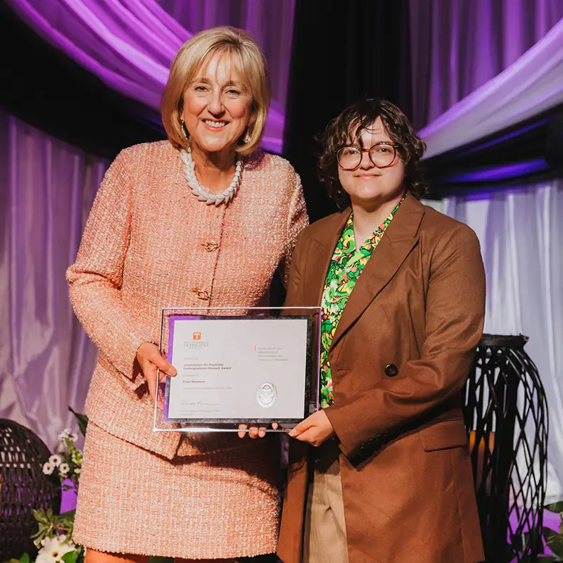 University of Tennessee Chancellor Donde Plowman presents the Commission for Disability Undergraduate Student Award to Evan Shannon for furthering recognition of and support for disabled people at UT