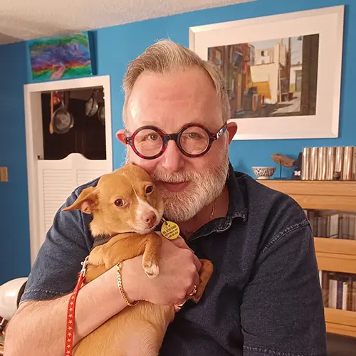 A man holding a dog